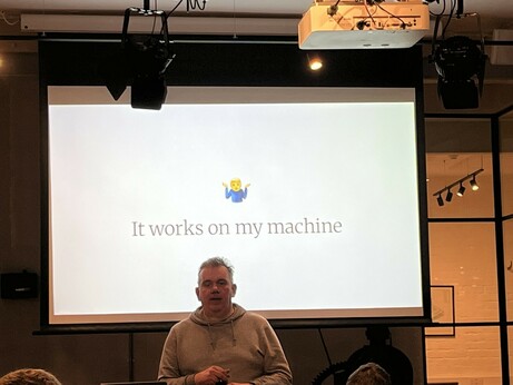Ciaran in front of a slide reading “It works on my machine” and a shrug emoji