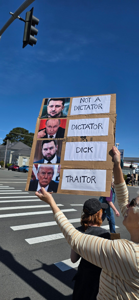 Sign at #HandsOff protest
From top to bottom: 
Photo of Zelensky NOT A DICTATOR
Photo of Putin DICTATOR
Photo of Vance DICK
Photo of Trump TRAITOR